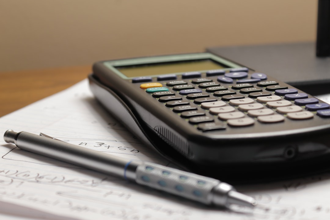 how to remove the vig - a calculator and a pen sitting on top of a piece of paper