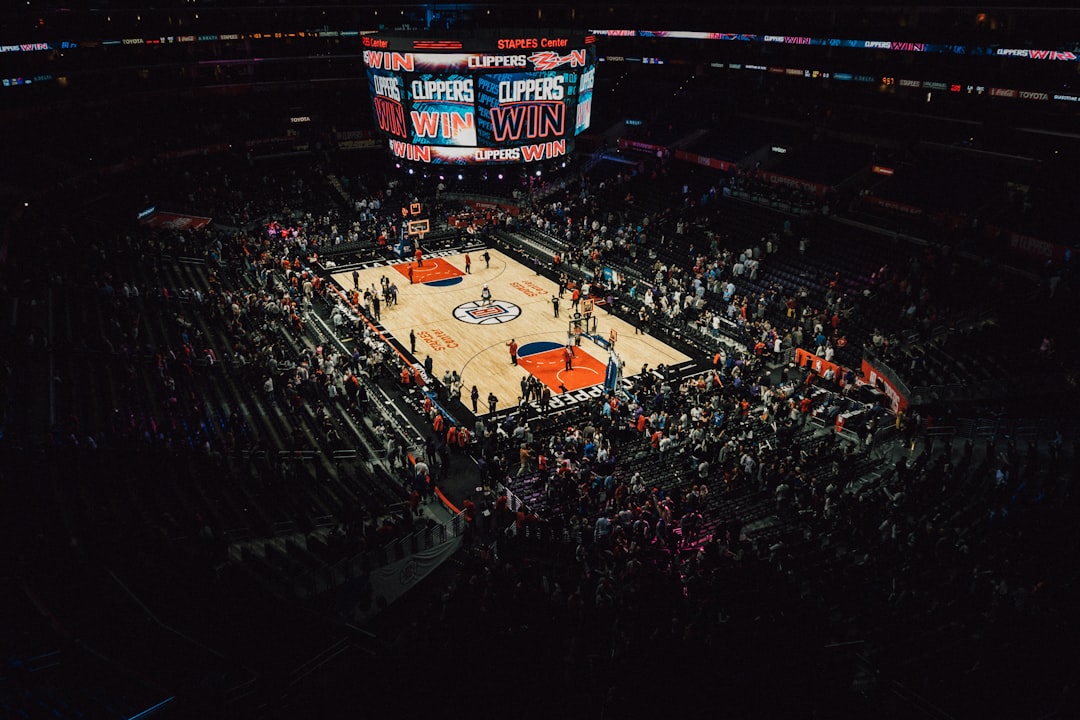 nba totals betting - people watching football game during nighttime